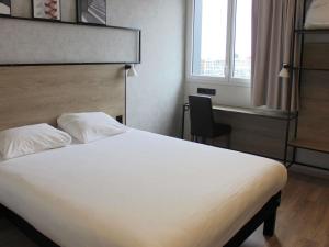 a bedroom with a bed and a chair and a window at ibis Dijon Sud in Perrigny-lès-Dijon +78 photos