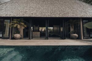 a house with a swimming pool in front of a house at MIZU Boutique Villas - Unique stay in Uluwatu in Uluwatu +168 photos