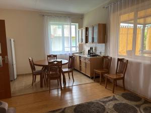 a kitchen with a table and chairs in a room at Lovely House in Cholpon-Ata