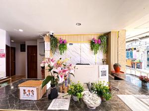 a lobby with flowers on a counter in a store at Aura Hotel Phi Phi in Phi Phi Islands