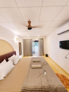 a bedroom with a large bed with two pillows at Mayura sea view in Malpe