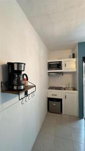 a small kitchen with a stove and a microwave at Departamento MAR in Coatzacoalcos