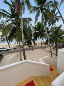 a view of the beach from the balcony of a house at Mayura sea view in Malpe