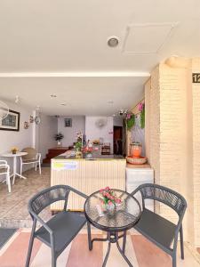 a dining table and two chairs in a kitchen at Aura Hotel Phi Phi in Phi Phi Islands