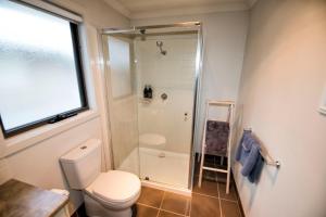 a bathroom with a toilet and a shower at Flinders Rest in Queenscliff +5 photos
