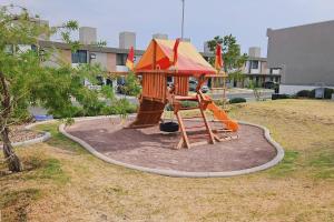 a small playground with a slide in a park at Tu espacio ideal en Intercity Urban Corridor in Querétaro