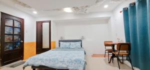 a bedroom with a bed and a table in it at Myths Saigon in Ho Chi Minh City +61 photos