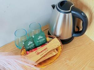 a basket of cookies and a tea kettle on a table at LV TPHomes in Ho Chi Minh City
