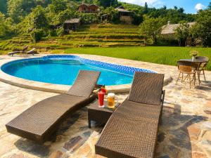 two wicker chairs sitting next to a swimming pool at Best View Homestay in Sapa