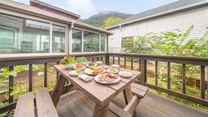 a wooden table with plates of food on a deck at Gapyeong Shiny Pension in Gapyeong