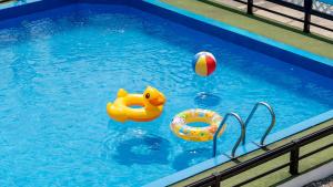 a swimming pool with two toys in the water at Gapyeong Shiny Pension in Gapyeong
