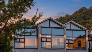 a glass house with a mountain in the background at Gapyeong Shiny Pension in Gapyeong
