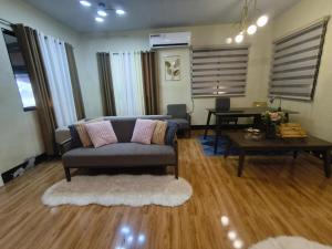 a living room with a couch and a table at Nonoy's Haven in Dipolog