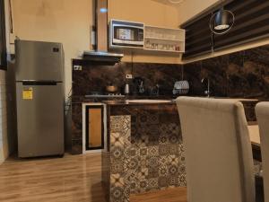 a kitchen with a refrigerator and a counter top at Nonoy's Haven in Dipolog +15 photos