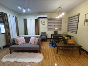 a living room with a couch and a table at Nonoy's Haven in Dipolog