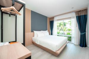 a bedroom with a white bed and a window at The One Cozy, Phuket in Chalong +127 photos