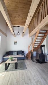 a living room with a blue couch and a table at Domki nad potokiem in Stary Sącz