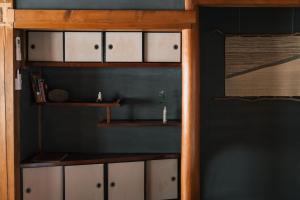 a room with white cabinets and a shelf at CAFE & BB guri in Ine
