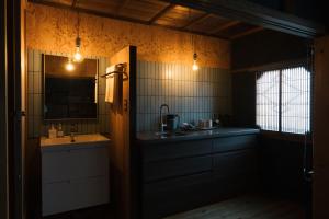 a bathroom with a sink and a mirror and a sink at CAFE & BB guri in Ine