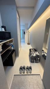 a room with two pairs of shoes on the floor at attomi hostel 2 in Sapporo +38 photos