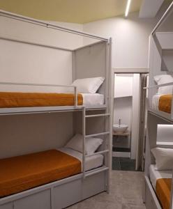 a room with three bunk beds and a sink at Il Sassolino in Riomaggiore +34 photos