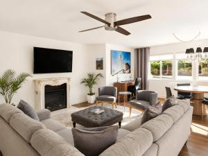 a living room with a couch and a fireplace at Gloria Palm Springs in Palm Springs