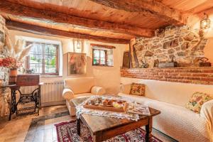 a living room with a couch and a table at Luin Country House near Štanjel - Happy Rentals in Štanjel