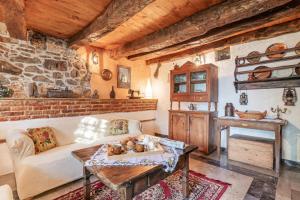 a living room with a couch and a table at Luin Country House near Štanjel - Happy Rentals in Štanjel