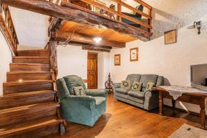 a living room with two chairs and a table at Luin Country House near Štanjel - Happy Rentals in Štanjel