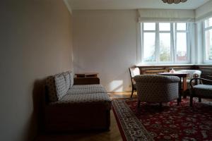 a living room with two chairs and a couch at Apartmán u stadionu in Broumov