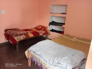 a room with two beds in a room at Chaukhamba hill homestay in Ukhimath
