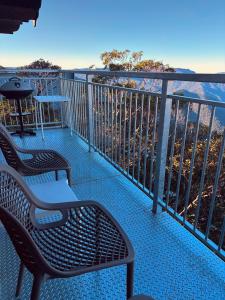 a balcony with two chairs and a table at Mount Buller Apartment in Mount Buller