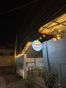 a sign for a fancy foods restaurant at night at Honey guest Batticaloa in Batticaloa +1 photo