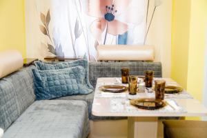 a living room with a couch and a table at P51 Central - Modern 2 Bedroom Apartment in Stara Zagora