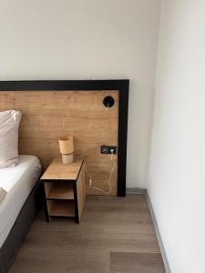 a bedroom with a bed and a night stand with a lamp at Blue Stay 2 in Bremen +3 photos