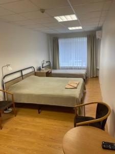 a hospital room with two beds and a chair at Jazz Time Studio in Birštonas