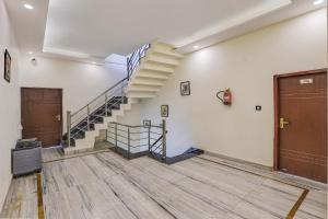 an empty room with a staircase in a building at Super Hotel O Clock Tower Dehradun Formerly Dooncity Suites in Dehradun +37 photos