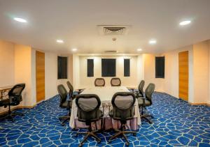 a conference room with a table and chairs in it at Bloom Boutique Bangalore Palace Rd in Bangalore