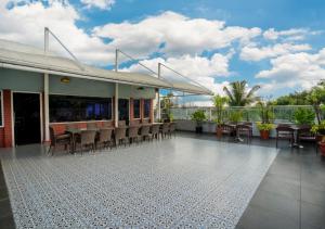 a patio with chairs and tables on a building at Bloom Boutique Bangalore Palace Rd in Bangalore