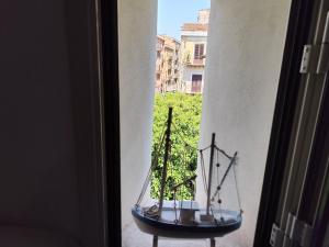 a model boat sitting on a table in a window at L'altra opera in Palermo