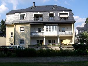 a large white house with a roof at Park-Villa in Bad Steben