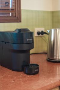 a coffee maker on a counter next to a pot at the Lodge farm house in Hindmarsh Valley