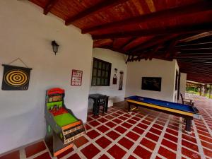 a room with a ping pong table and a pool table at Hotel Campestre Jardín Cafetero - Quindio in Armenia
