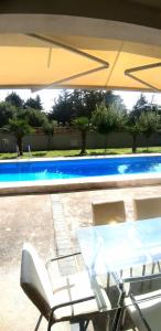 a table and chairs next to a swimming pool at Holiday Home in Gevgelija
