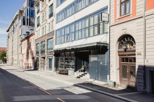 an empty city street with buildings and a store at Home Hotel Bastion in Oslo
