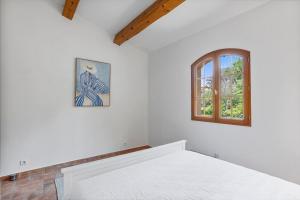 a bedroom with a bed and a window at Modern Holiday Home Pool & Wifi in Roquebrune-sur-Argens +32 photos