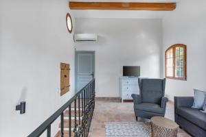 a living room with a couch and a chair at Modern Holiday Home Pool & Wifi in Roquebrune-sur-Argens