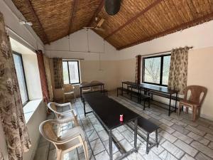 a room with a table and chairs in a room at Maanjoofarms Pilani in Pilani