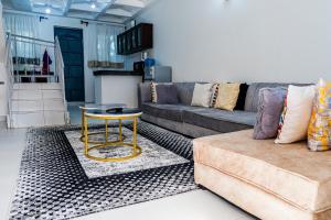 a living room with a couch and a table at Serena Road Villa C in Mombasa
