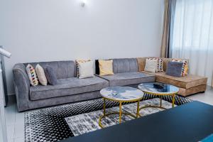 a living room with a couch and two tables at Serena Road Villa C in Mombasa